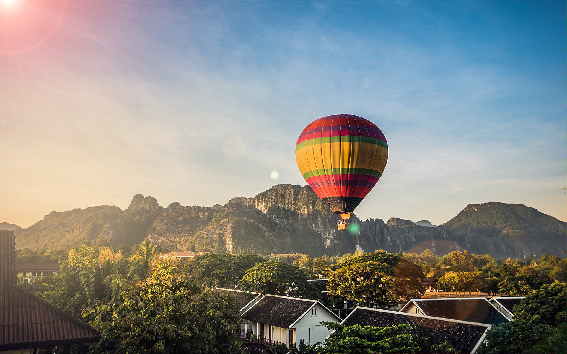 Hot air balloon over Vang Vieng karsts at sunrise